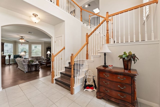 2907 Briona Wood Ln, Cedar Park, TX 78613 - staircase with arched walkways, ceiling fan, and tile patterned flooring