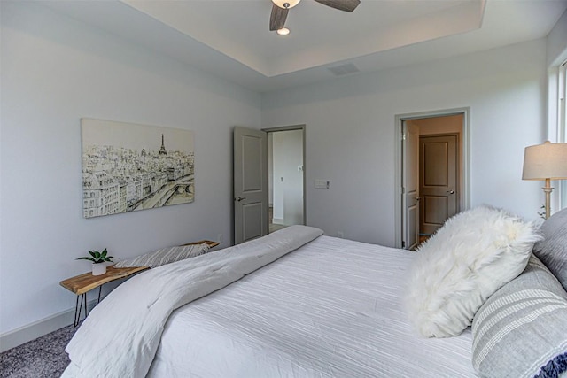 bedroom with a raised ceiling, ceiling fan, carpet floors, and recessed lighting