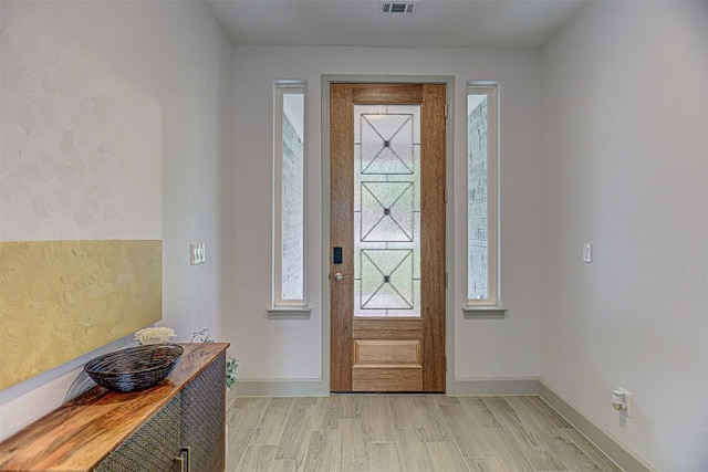 162 Puu Waa Waa Ln, Bastrop, TX 78602 - foyer entrance with baseboards and light wood finished floors