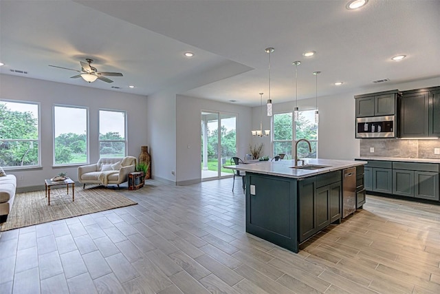 162 Puu Waa Waa Ln, Bastrop, TX 78602 - kitchen featuring open floor plan, appliances with stainless steel finishes, a sink, ceiling fan, and baseboards