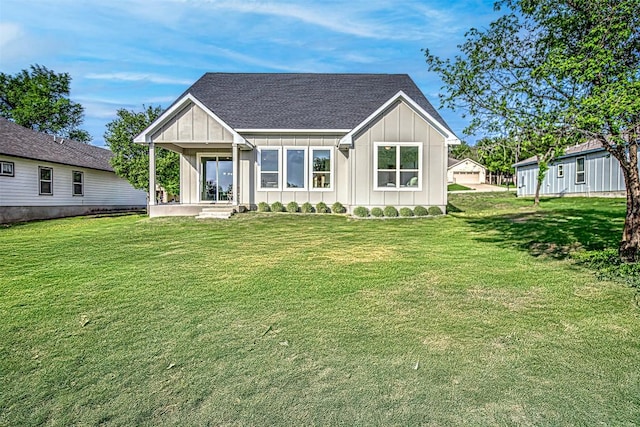162 Puu Waa Waa Ln, Bastrop, TX 78602 - view of front of home featuring board and batten siding, a front yard, and roof with shingles