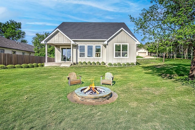 162 Puu Waa Waa Ln, Bastrop, TX 78602 - rear view of property featuring board and batten siding, an outdoor fire pit, and roof with shingles