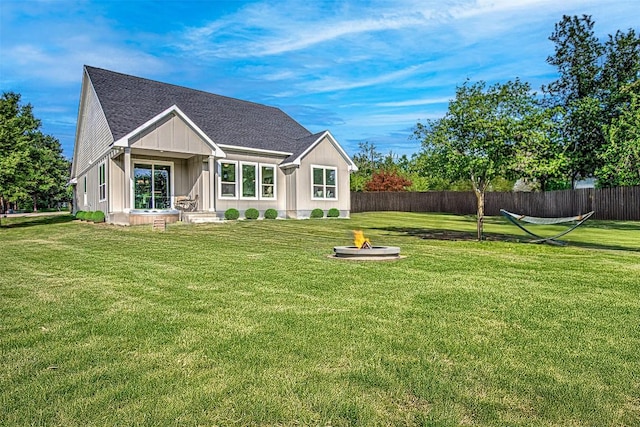 162 Puu Waa Waa Ln, Bastrop, TX 78602 - view of front of home featuring a fire pit, a shingled roof, and board and batten siding