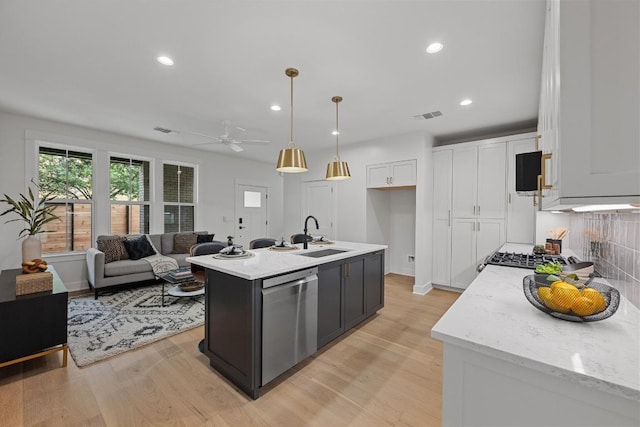 1906 Willow St Unit 2, Austin, TX 78702 - kitchen featuring dishwasher, white cabinets, light wood-type flooring, recessed lighting, and a ceiling fan