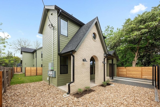 1906 Willow St Unit 2, Austin, TX 78702 - view of home's exterior with brick siding and a shingled roof