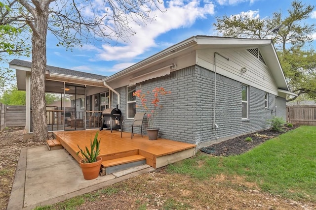 1701 Davis St, Taylor, TX 76574 - back of property featuring a wooden deck, a sunroom, and a ceiling fan