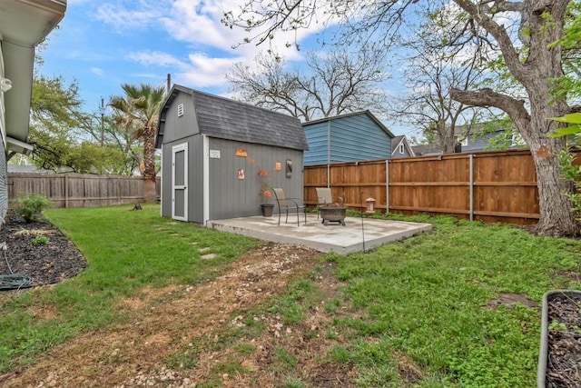 1701 Davis St, Taylor, TX 76574 - fenced backyard featuring a patio, an outdoor fire pit, and a storage unit