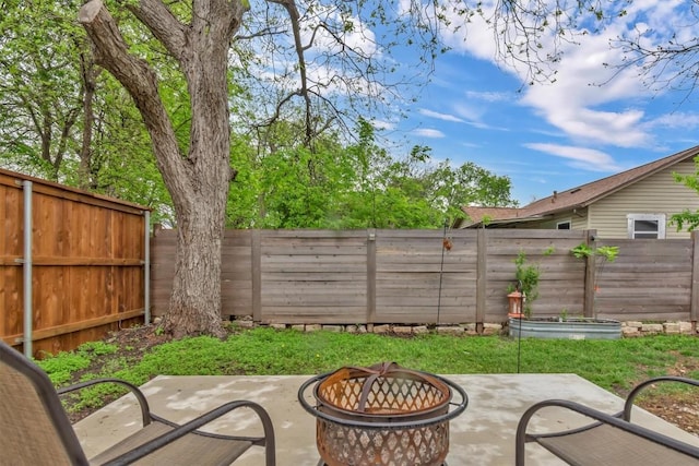 1701 Davis St, Taylor, TX 76574 - fenced backyard with an outdoor fire pit and a patio