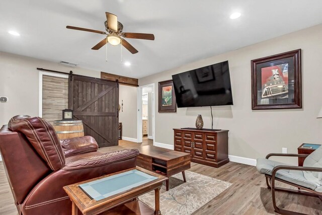 1701 Davis St, Taylor, TX 76574 - living area with a ceiling fan, a barn door, light wood-type flooring, and recessed lighting