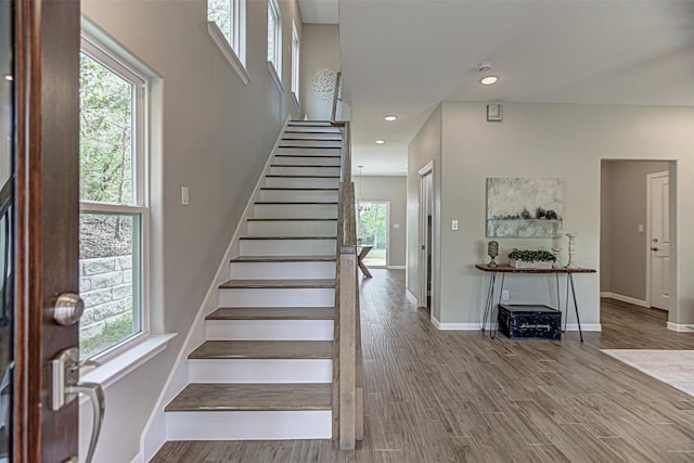 stairway featuring baseboards and a wealth of natural light