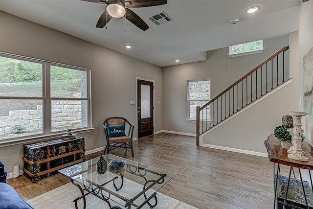 living room with ceiling fan, stairs, recessed lighting, wood finished floors, and visible vents