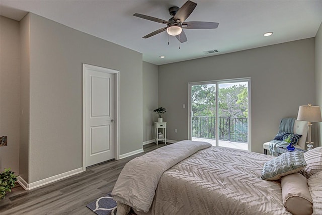 bedroom featuring baseboards, wood finished floors, visible vents, and access to exterior