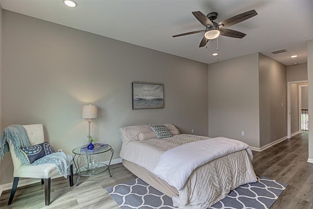 bedroom featuring ceiling fan, recessed lighting, baseboards, wood finished floors, and visible vents