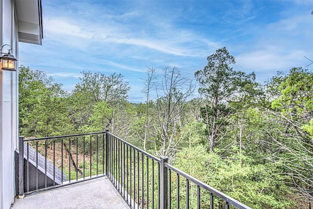 balcony featuring a wooded view