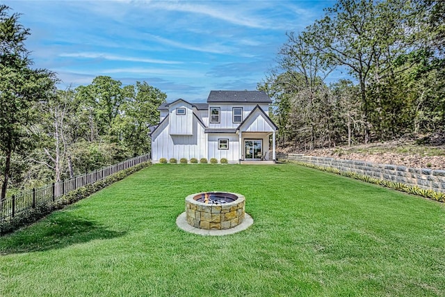 153 E Keanahalululu Ln, Bastrop, TX 78602 - view of front of property with board and batten siding, an outdoor fire pit, and french doors