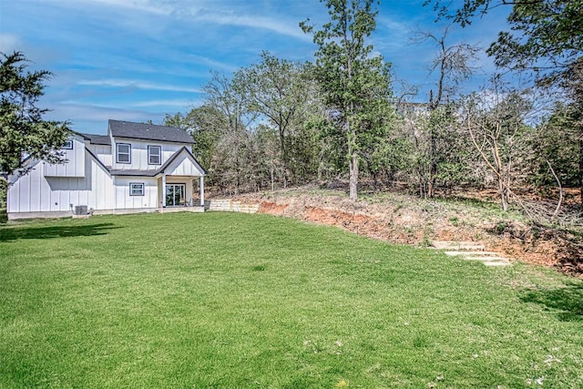 153 E Keanahalululu Ln, Bastrop, TX 78602 - view of grassy yard featuring central air condition unit