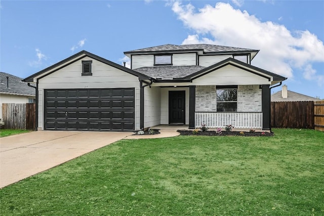 traditional home featuring a garage, fence, concrete driveway, and a front yard