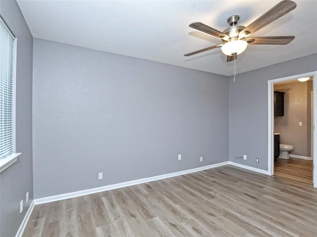 118 Dogwood Dr, Georgetown, TX 78626 - unfurnished bedroom with connected bathroom, baseboards, light wood-type flooring, and ceiling fan