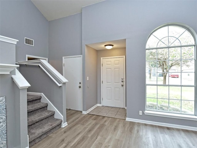 118 Dogwood Dr, Georgetown, TX 78626 - entryway with stairs, baseboards, a high ceiling, light wood finished floors, and visible vents
