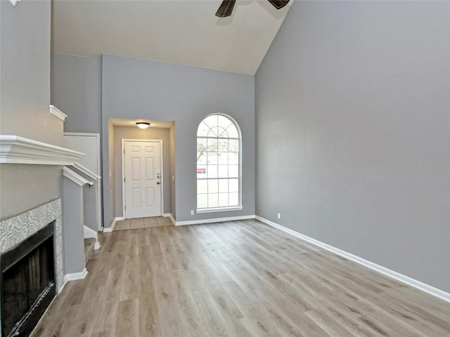 118 Dogwood Dr, Georgetown, TX 78626 - unfurnished living room featuring baseboards, a fireplace, light wood-style floors, and a ceiling fan