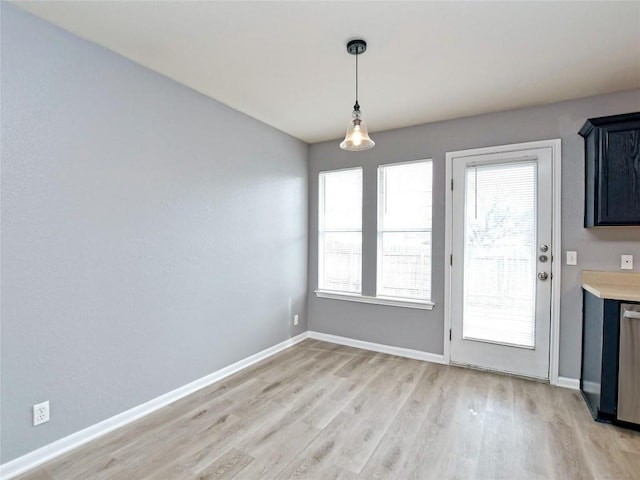 118 Dogwood Dr, Georgetown, TX 78626 - unfurnished dining area with light wood-style flooring and baseboards