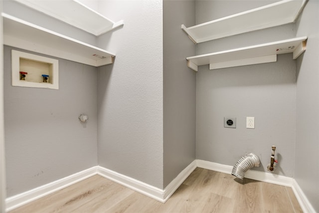 118 Dogwood Dr, Georgetown, TX 78626 - laundry room with hookup for a gas dryer, washer hookup, light wood-type flooring, hookup for an electric dryer, and laundry area