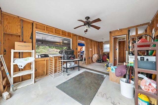 932 Scenic Loop, Kingsland, TX 78639 - miscellaneous room featuring unfinished concrete floors, a ceiling fan, and wood walls