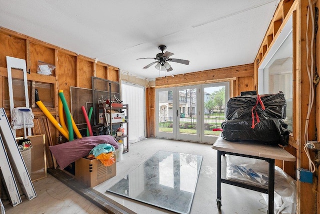 932 Scenic Loop, Kingsland, TX 78639 - living room featuring ceiling fan and wood walls