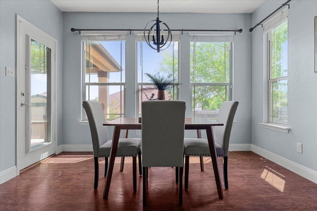 100 Matthews, Kyle, TX 78640 - dining area with a chandelier, baseboards, and dark wood-type flooring