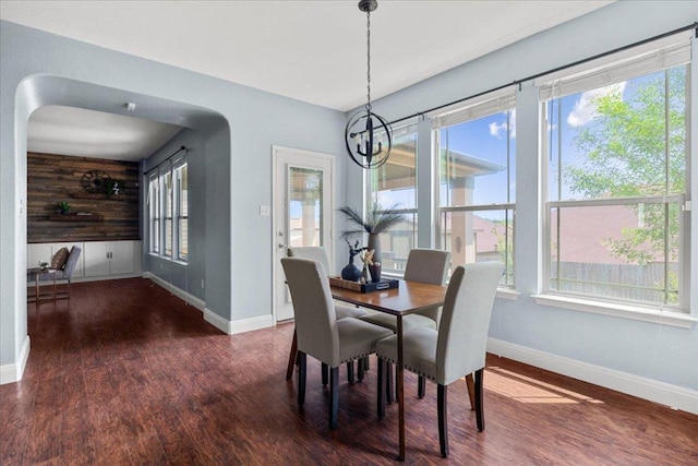 100 Matthews, Kyle, TX 78640 - dining area featuring wood finished floors, wooden walls, and a chandelier