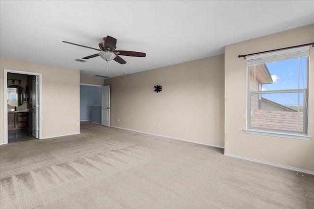 100 Matthews, Kyle, TX 78640 - unfurnished bedroom with carpet flooring, baseboards, connected bathroom, and ceiling fan