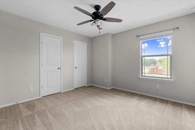 100 Matthews, Kyle, TX 78640 - unfurnished bedroom with carpet floors, baseboards, and a ceiling fan