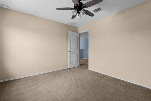 100 Matthews, Kyle, TX 78640 - unfurnished room with a ceiling fan, light carpet, baseboards, and a smoke detector