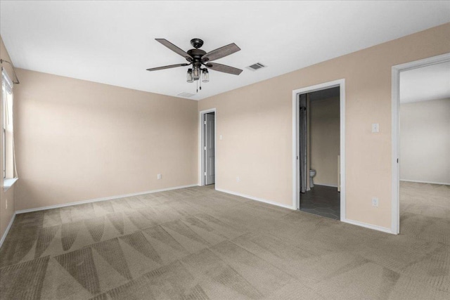 100 Matthews, Kyle, TX 78640 - unfurnished bedroom with carpet floors, baseboards, a ceiling fan, and ensuite bathroom