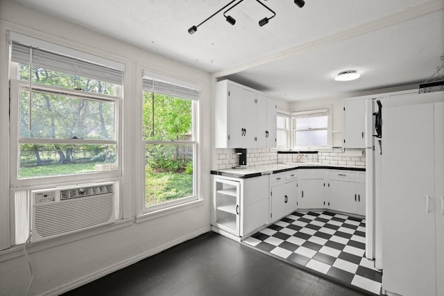 7202 Marcell St, Austin, TX 78752 - kitchen featuring white cabinets, decorative backsplash, tile patterned floors, open shelves, and cooling unit