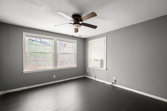 7202 Marcell St, Austin, TX 78752 - unfurnished room featuring a ceiling fan, dark wood finished floors, cooling unit, a textured wall, and a textured ceiling