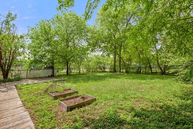 7202 Marcell St, Austin, TX 78752 - fenced backyard featuring a vegetable garden