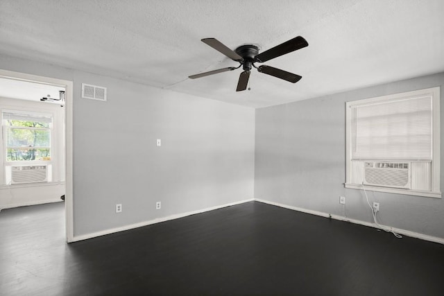 7202 Marcell St, Austin, TX 78752 - unfurnished room featuring wood finished floors, ceiling fan, a textured ceiling, and cooling unit
