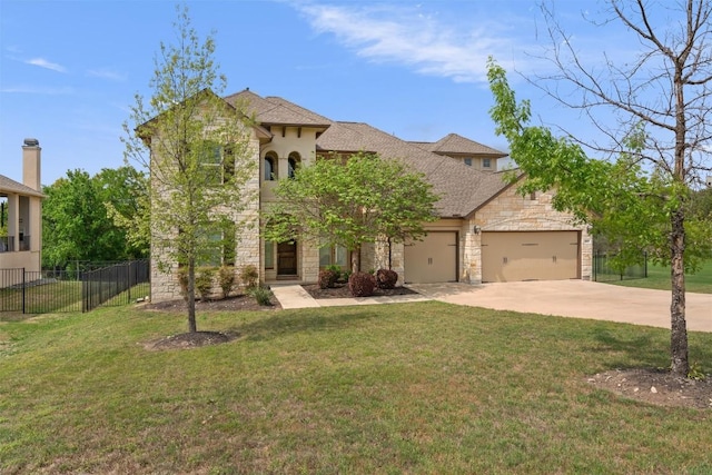 traditional home with fence, stone siding, a front yard, concrete driveway, and an attached garage