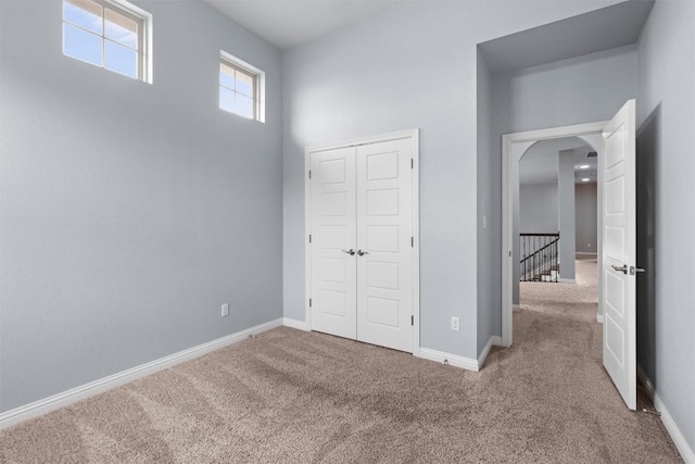 2015 Colina Cv, Cedar Park, TX 78613 - unfurnished bedroom featuring carpet, arched walkways, and a closet