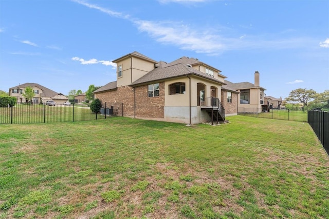 2015 Colina Cv, Cedar Park, TX 78613 - rear view of property featuring a fenced backyard, a chimney, brick siding, and stucco siding
