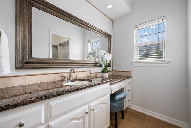 6605 Canon Wren Dr, Austin, TX 78746 - bathroom with plenty of natural light, baseboards, vanity, tile patterned flooring, and recessed lighting