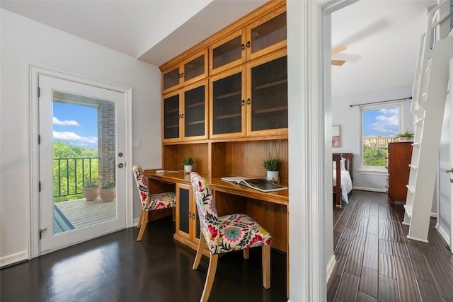 6605 Canon Wren Dr, Austin, TX 78746 - dining area with dark wood-type flooring, baseboards, and a desk