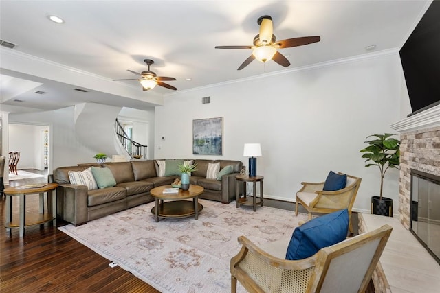 6605 Canon Wren Dr, Austin, TX 78746 - living area with a ceiling fan, stairway, crown molding, a stone fireplace, and wood finished floors