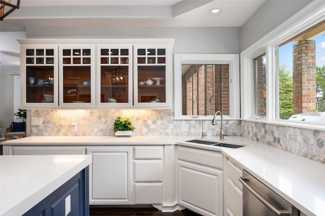 6605 Canon Wren Dr, Austin, TX 78746 - kitchen featuring a sink, stainless steel dishwasher, tasteful backsplash, white cabinetry, and light countertops