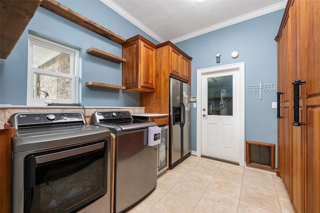 6605 Canon Wren Dr, Austin, TX 78746 - laundry room with washing machine and clothes dryer, cabinet space, ornamental molding, and light tile patterned floors
