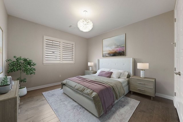 433 Chitalpa St, Leander, TX 78641 - bedroom featuring baseboards, hardwood / wood-style flooring, and a chandelier