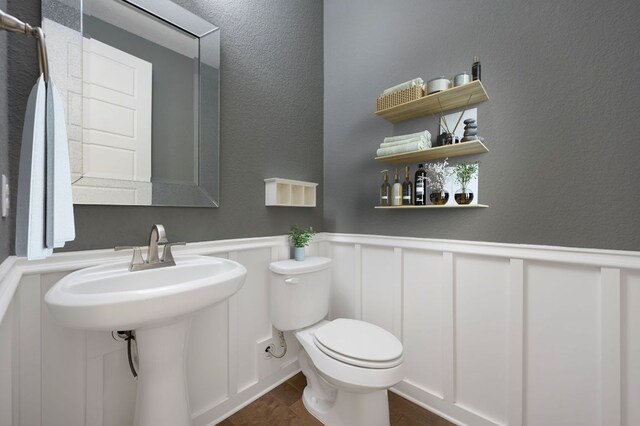 433 Chitalpa St, Leander, TX 78641 - bathroom featuring toilet, a wainscoted wall, wood finished floors, a decorative wall, and a textured wall