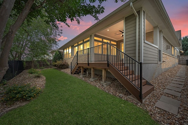 433 Chitalpa St, Leander, TX 78641 - back of house at dusk featuring stairs, ceiling fan, and a wooden deck