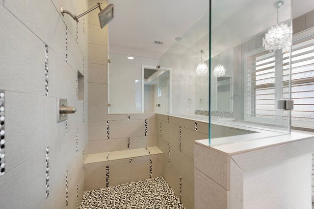 433 Chitalpa St, Leander, TX 78641 - full bathroom with a chandelier, a walk in shower, and tile walls